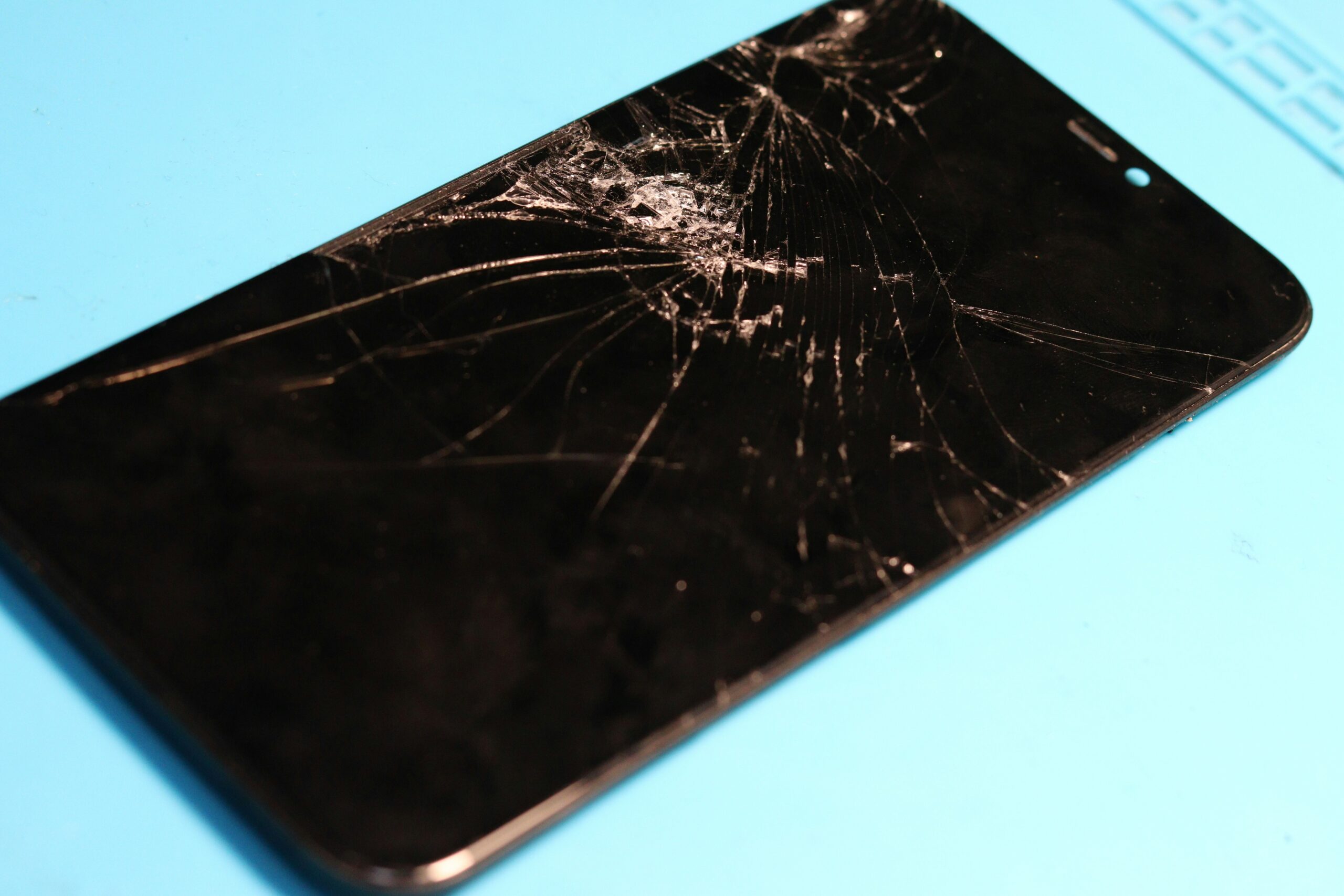 broken smartphone data recovery concept - Shattered phone screen: a glaring display of damage.