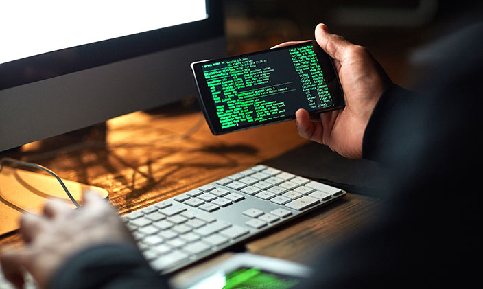 malicious code on smartphone screen - What Is Malicious Code? | University of Phoenix
