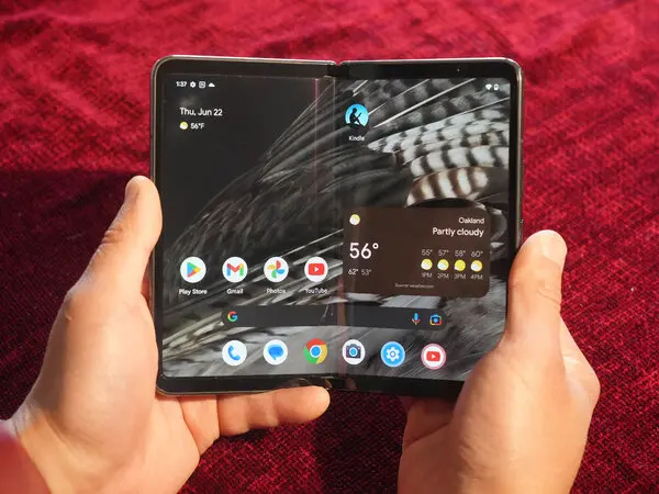 hand holding latest Google Pixel phone - Google Pixel Fold Review: Foldable Phones Are Improving - The New ...
