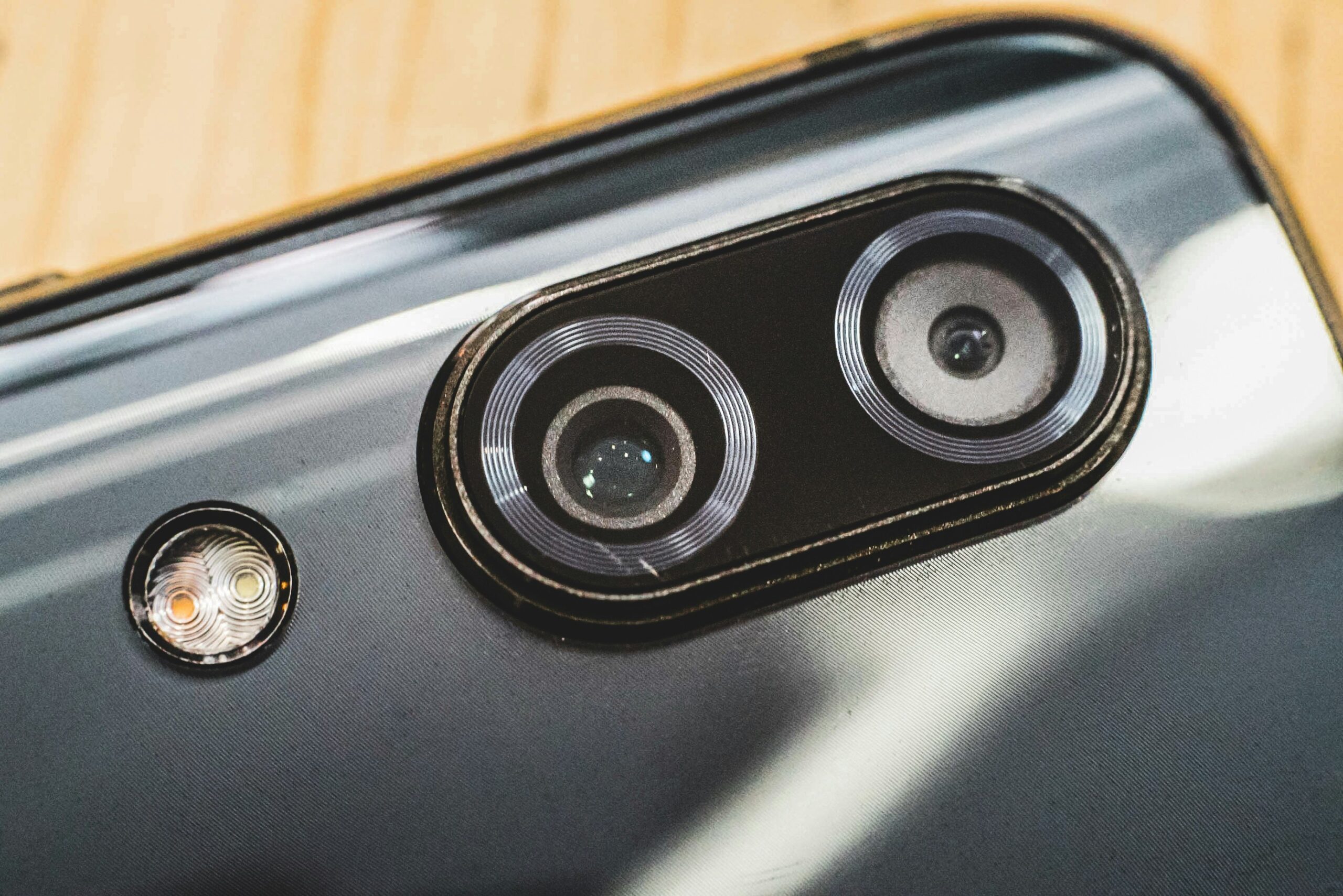Close-up of modern smartphone camera lenses - A smartphone with dual cams (wide and Telephoto) and dual-tone LED flash. 