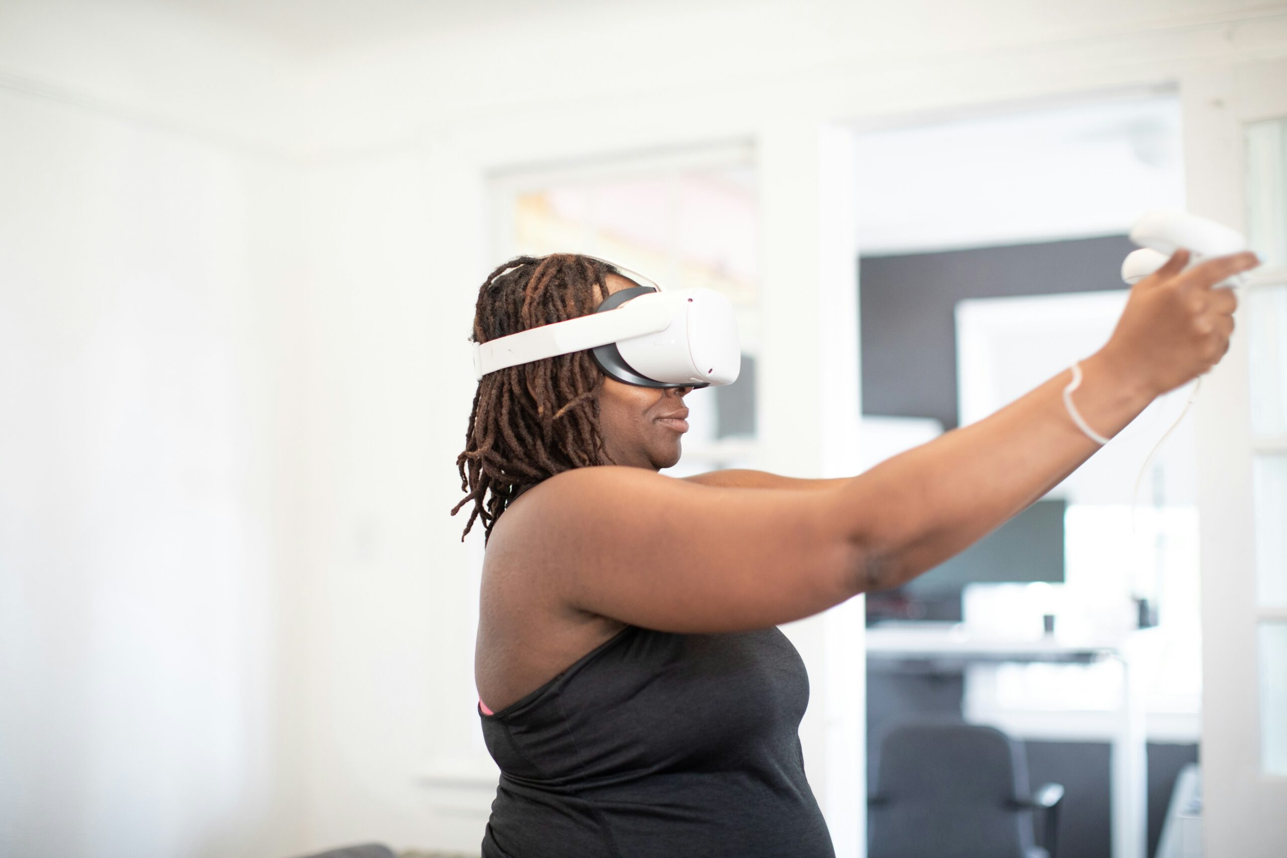 Keywords:
Woman wearing mixed reality headset interacting with virtual data - a woman playing video games