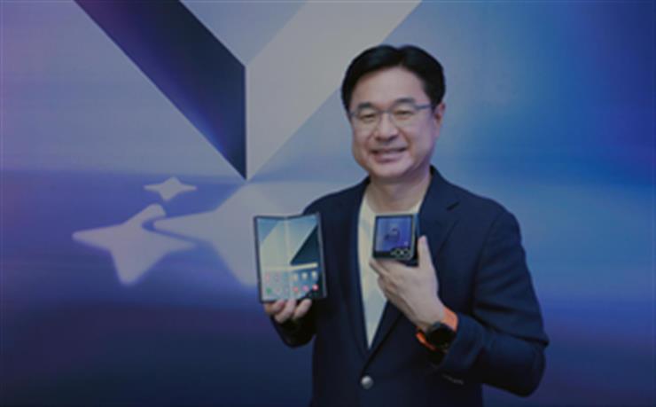 Man holding open foldable smartphone - Samsung reveals India pricing for new foldables, wearables